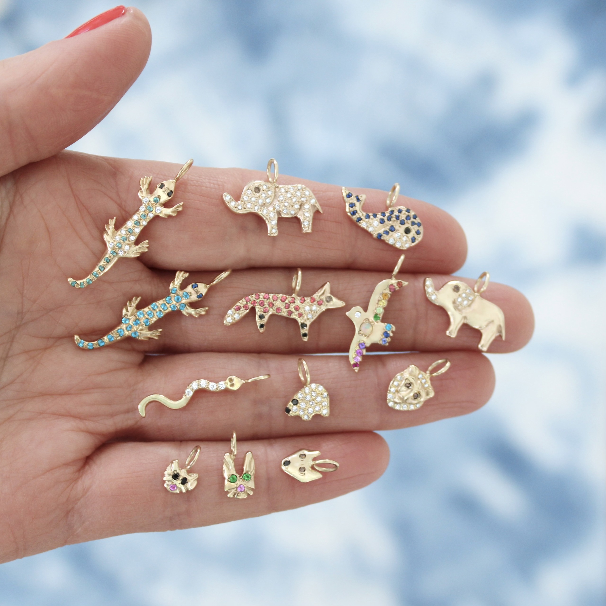 close-up-holding-gold-animal-charms
