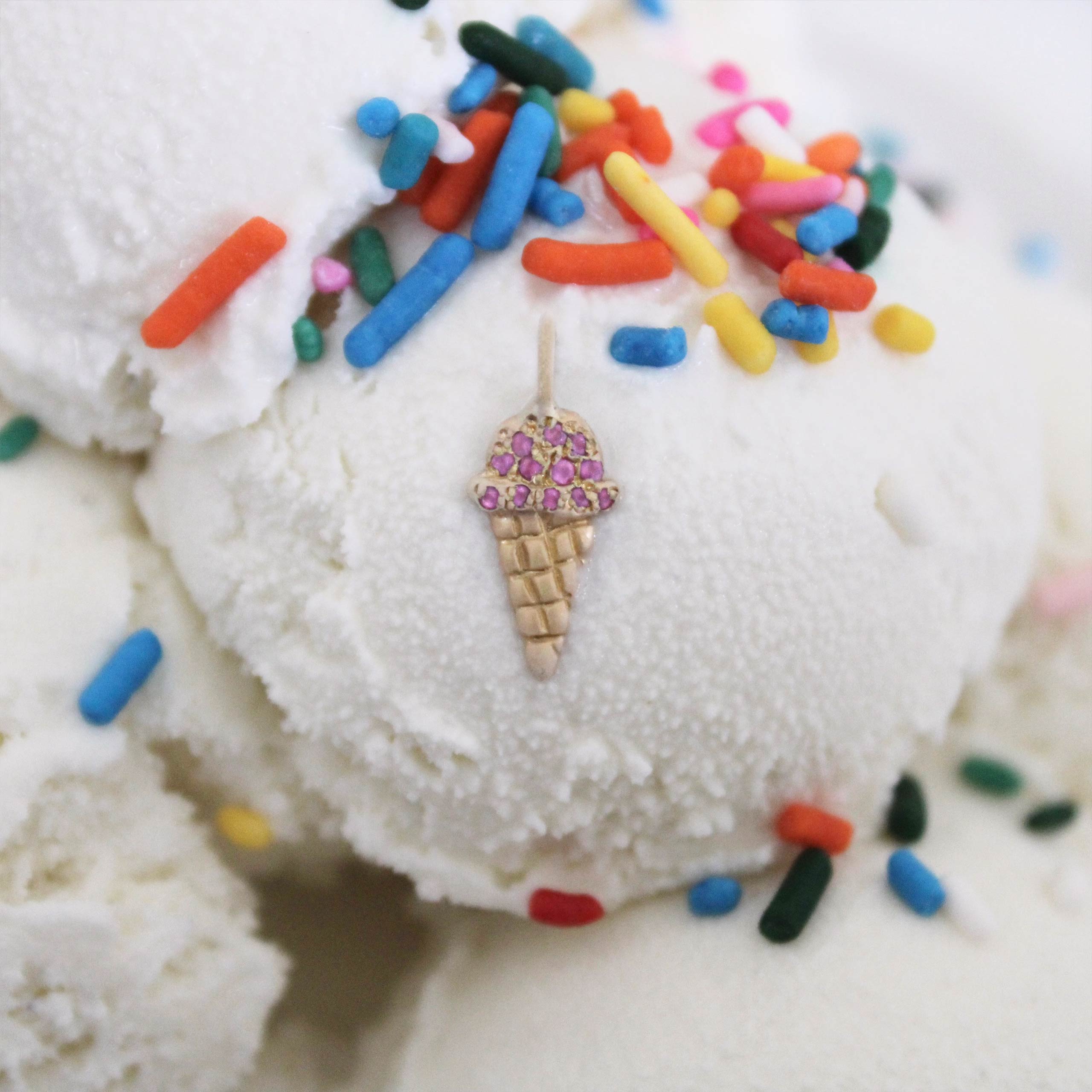 a-sweet-sparkly-treat gold ice cream cone charm with pink diamonds on top of an ice cream scoop with sprinkles